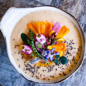 vegan coconut yoghurt smoothie bowl with edible flowers